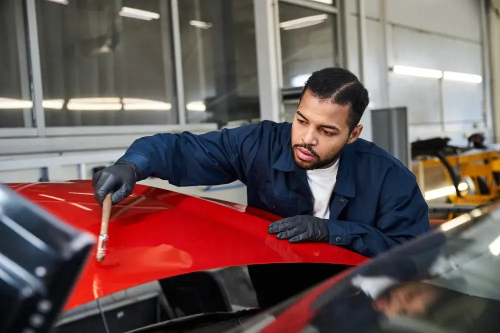 Mechanic working on a car bonet